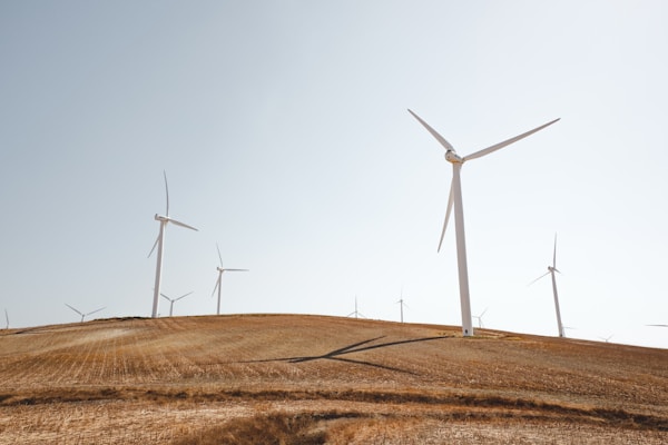 white electric windmills during daytime