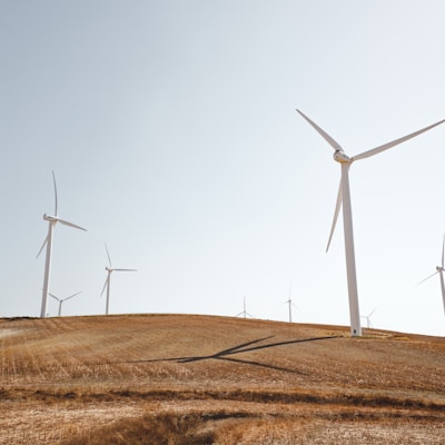 white electric windmills during daytime