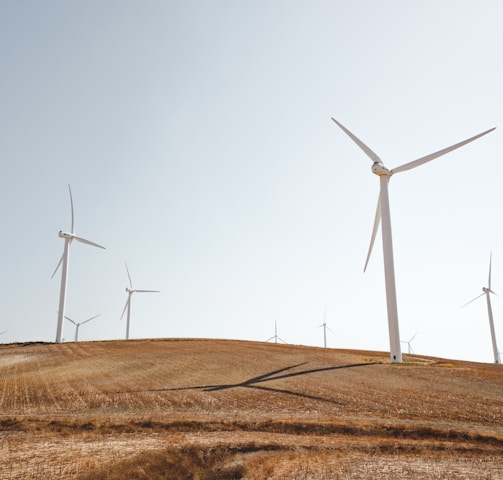 white electric windmills during daytime