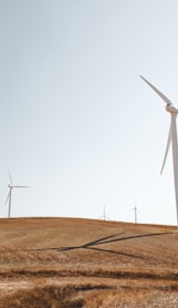 white electric windmills during daytime