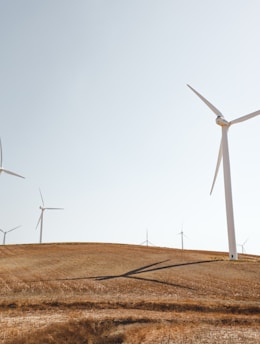 white electric windmills during daytime