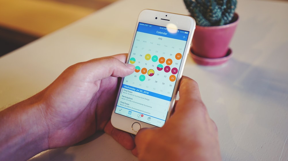 A person looking through the calendar on their smartphone.