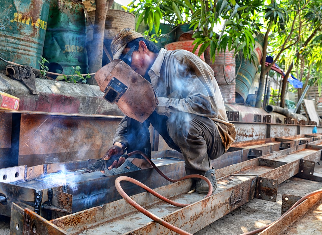 man using welding machine, Welder on steel bars