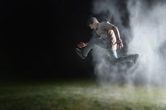 man in gray shirt jumping during night time