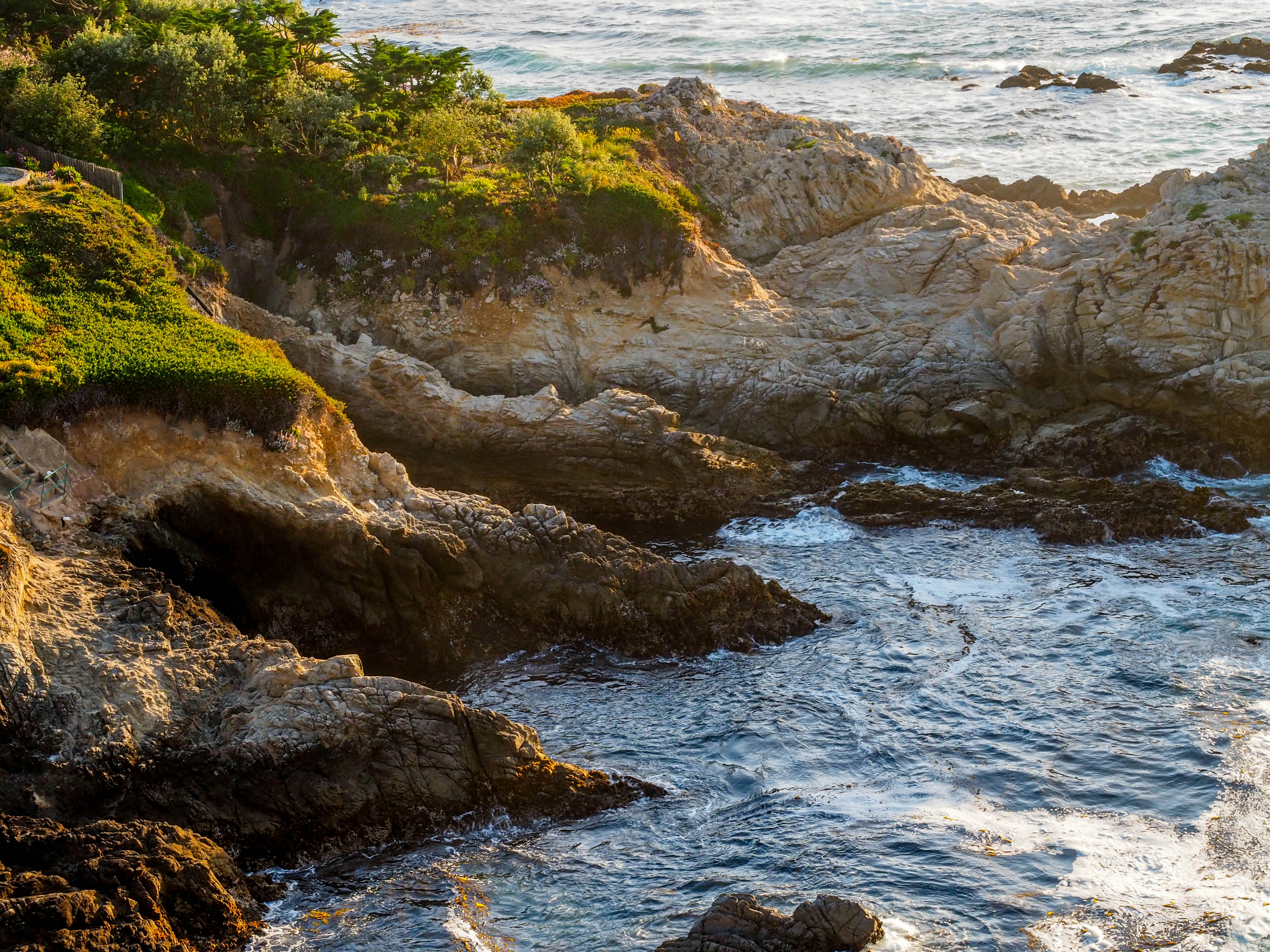aerial photo of rocks near body of water, 