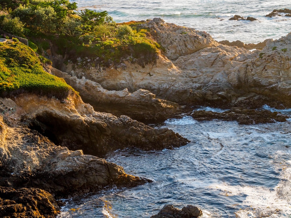 aerial photo of rocks near body of water