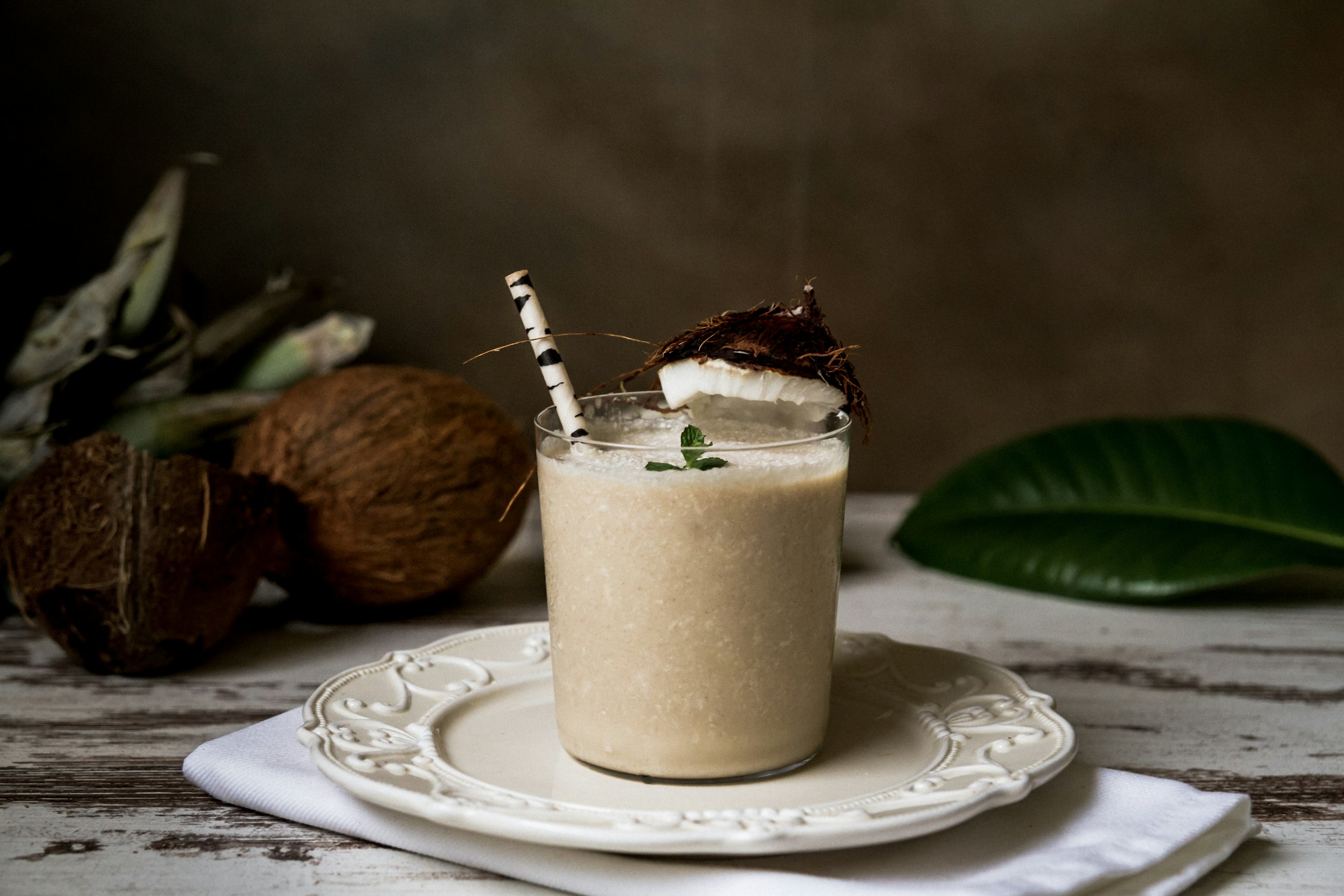 Coconut coffee drink in a glass and on a plate. 