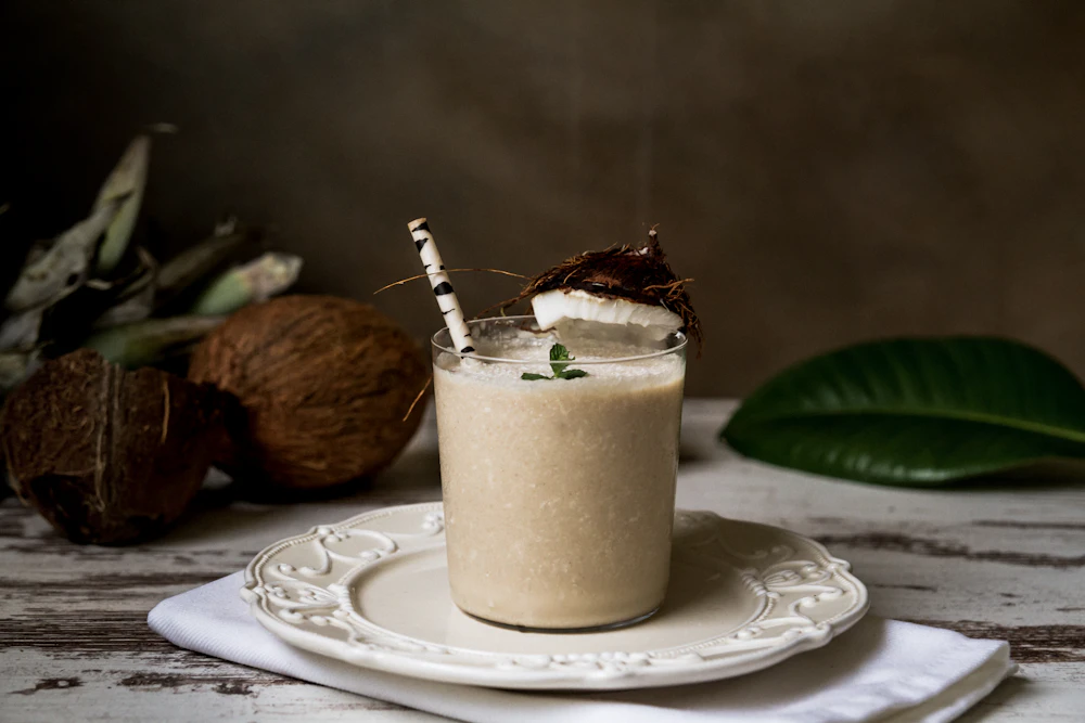 Creamy coconut smoothie garnished with mint