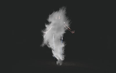 person standing near smoke with black background spirit google meet background