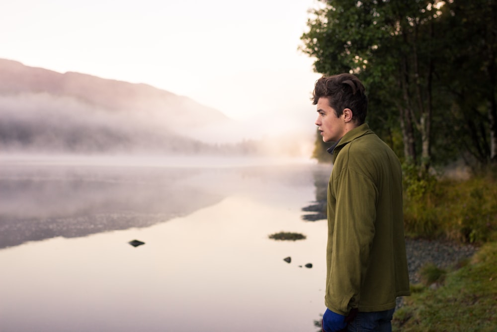 man staring at the body of water