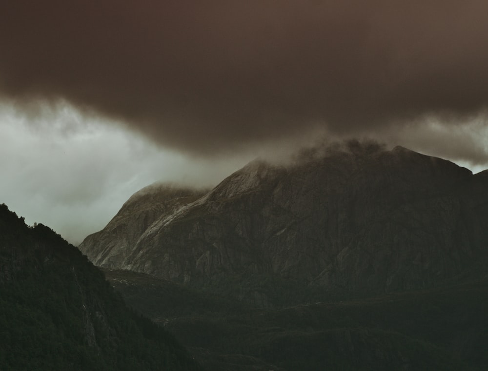 mountain covered by cumulus cloud