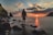 man standing on stone looking at sunset