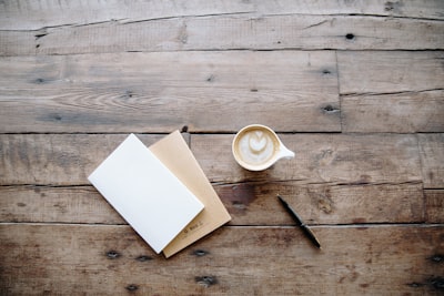 black twist pen near white teacup table google meet background