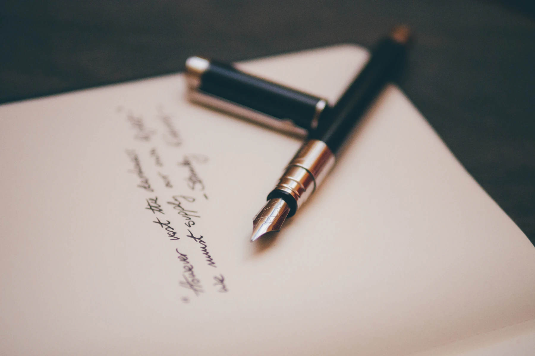 Fountain pen on a written sheet of paper