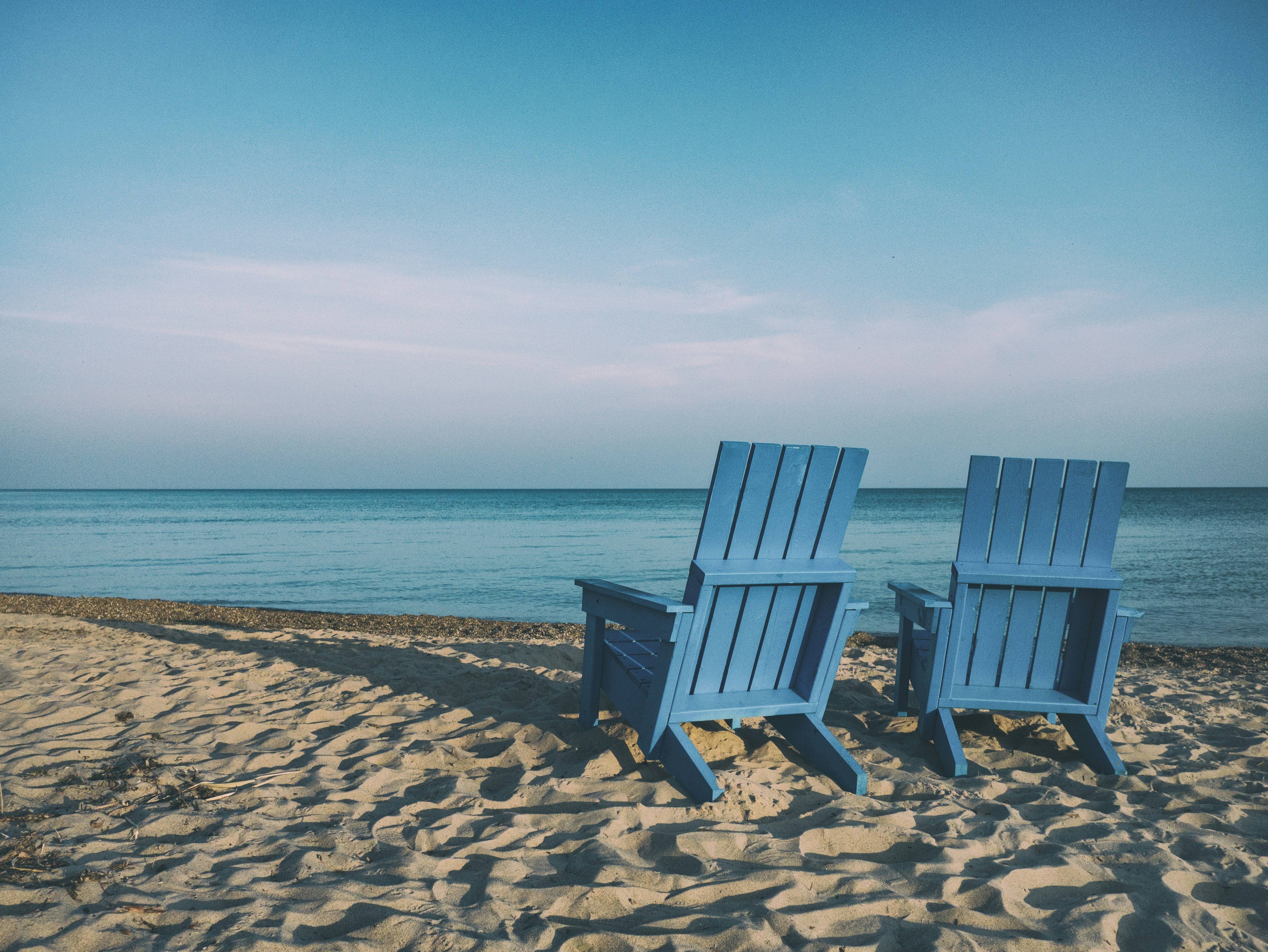 Image of two chairs on the beach representing how retirement will be. 