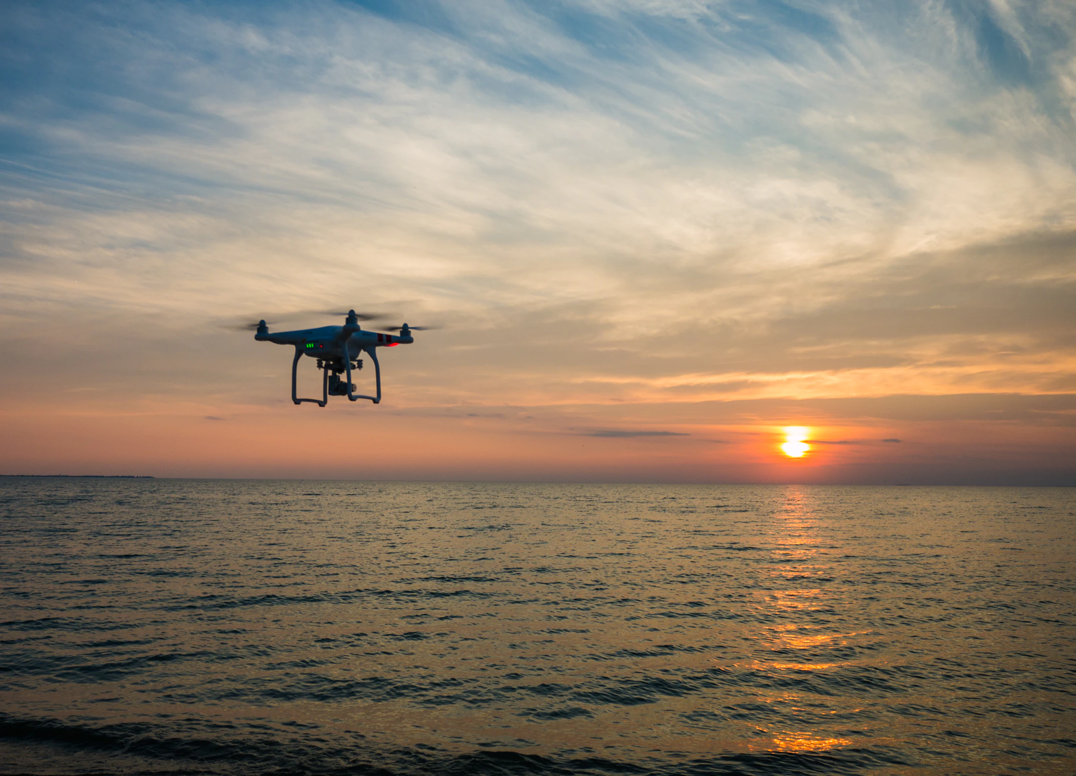 Drone flying above a remote body of water