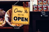 yellow and black come in we're open sign in a new business