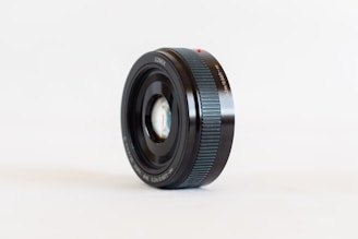 black camera lens on white surface