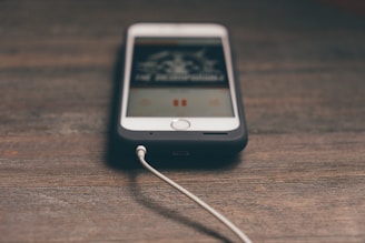 A close-up of a smartphone connecting wirelessly to a car's audio system.