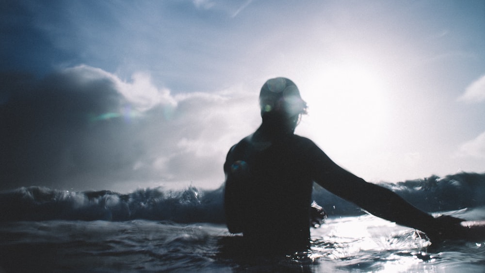 person on sea under blue sky