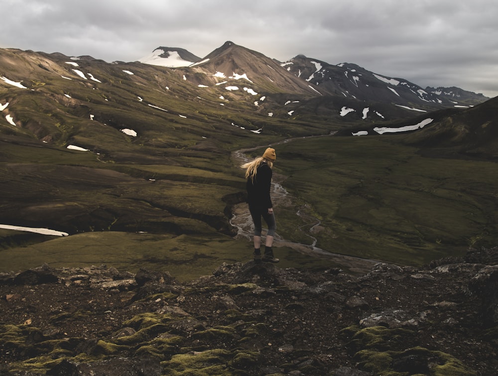 woman standing on cliff