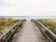 photo of gray wooden bridge