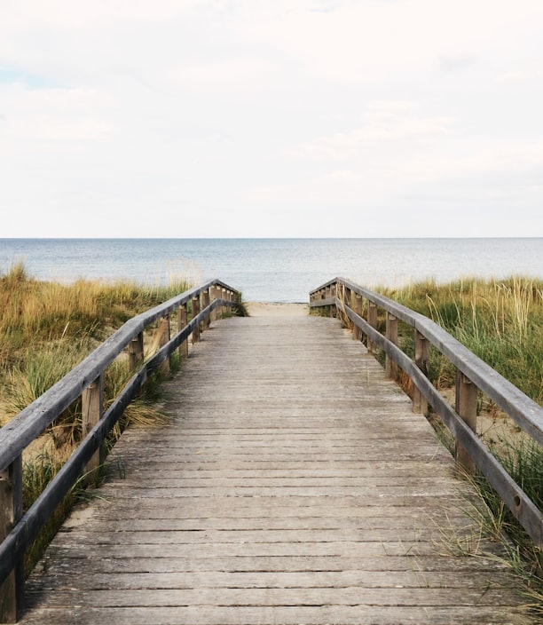 photo of gray wooden bridge