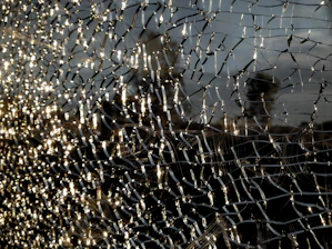 Close-up of colorful shattered glass pieces arranged artistically on a wooden table.