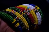 A set of colorful bracelets crafted from reclaimed plastic materials, showcasing texture and color.