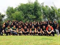 A group photo of association members and partners standing united outdoors.