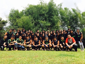 A group photo of association members and partners standing united outdoors.