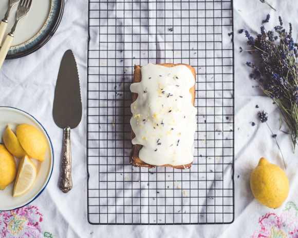 A cozy kitchen scene featuring a lemon pound cake cooling on a wire rack.
