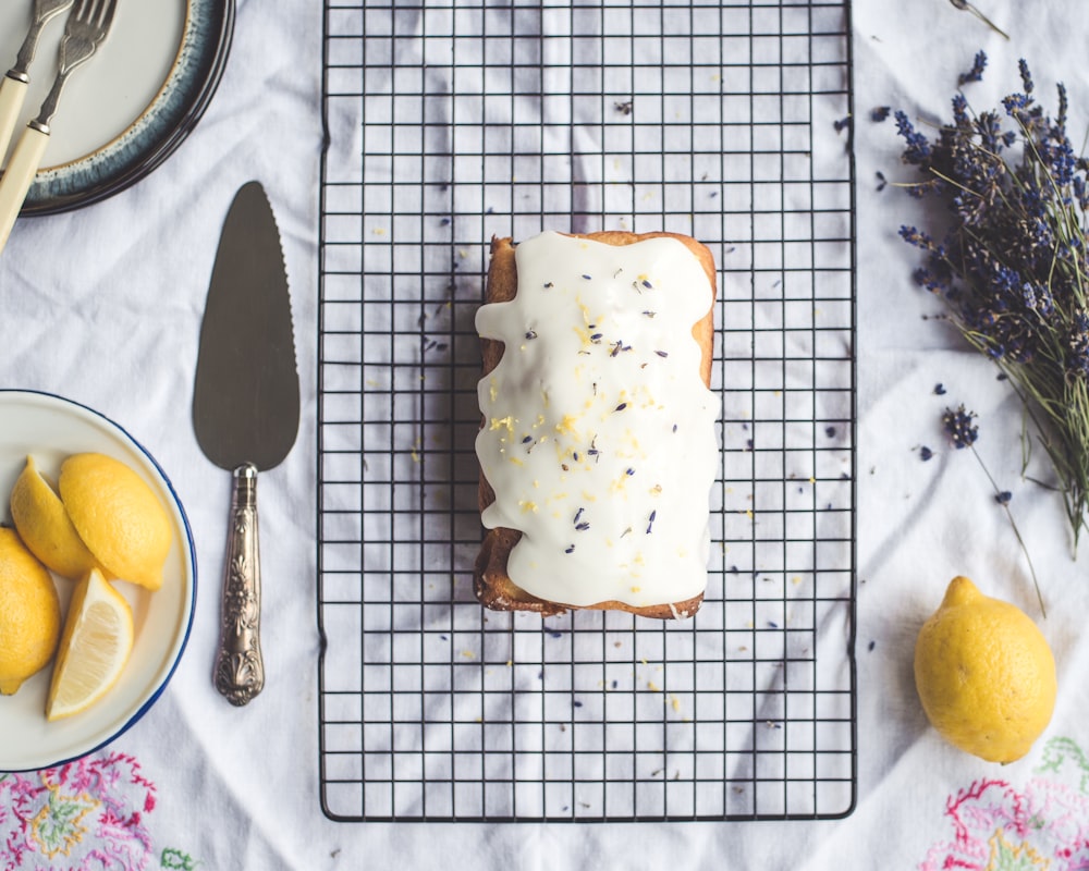 Freshly baked lemon cake with icing and lavender flowers