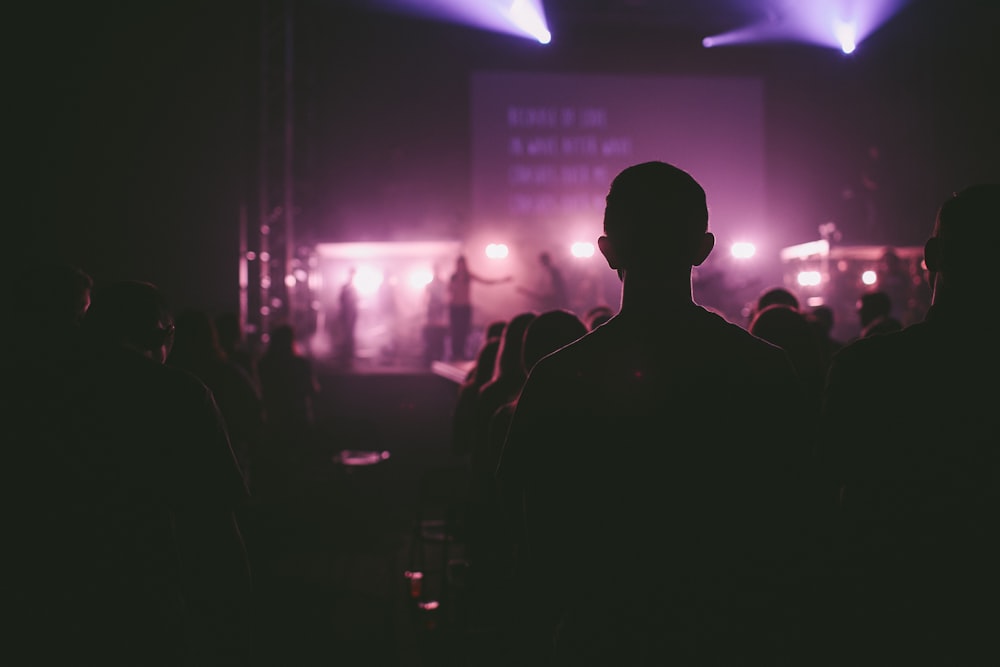 photo of man facing on stage