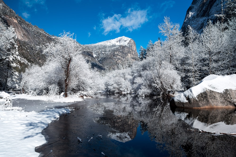 snow capped mountain near river at daytime