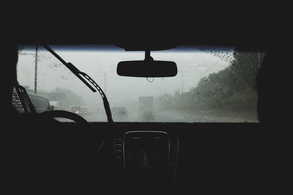 two person driving on rainy road