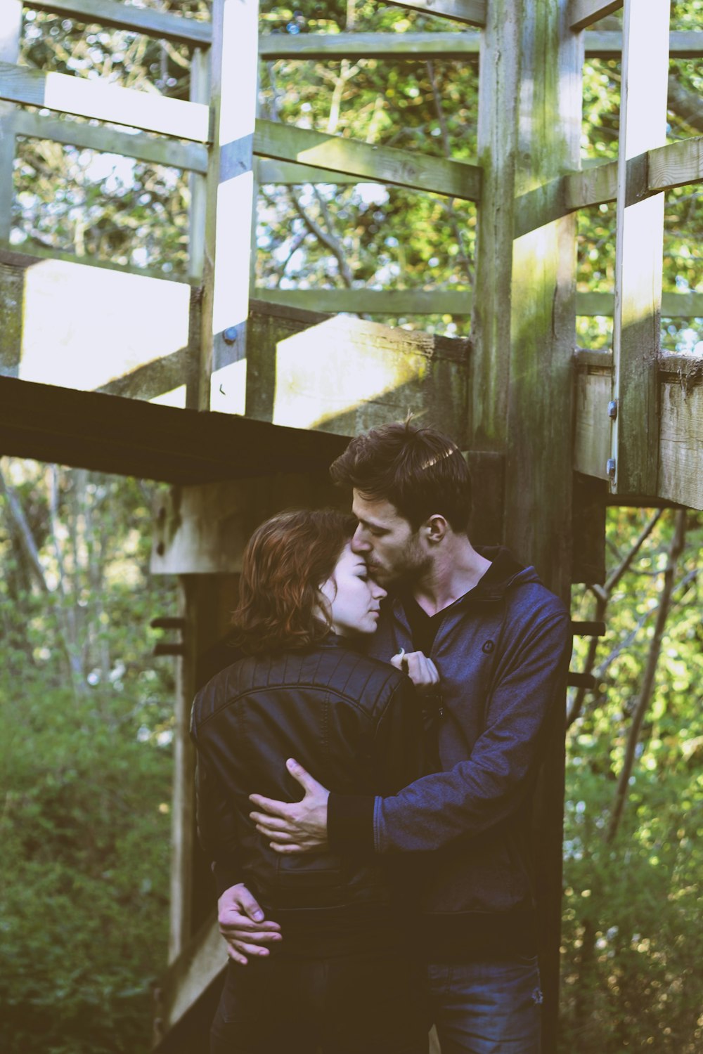 man and woman hugging on focus photography