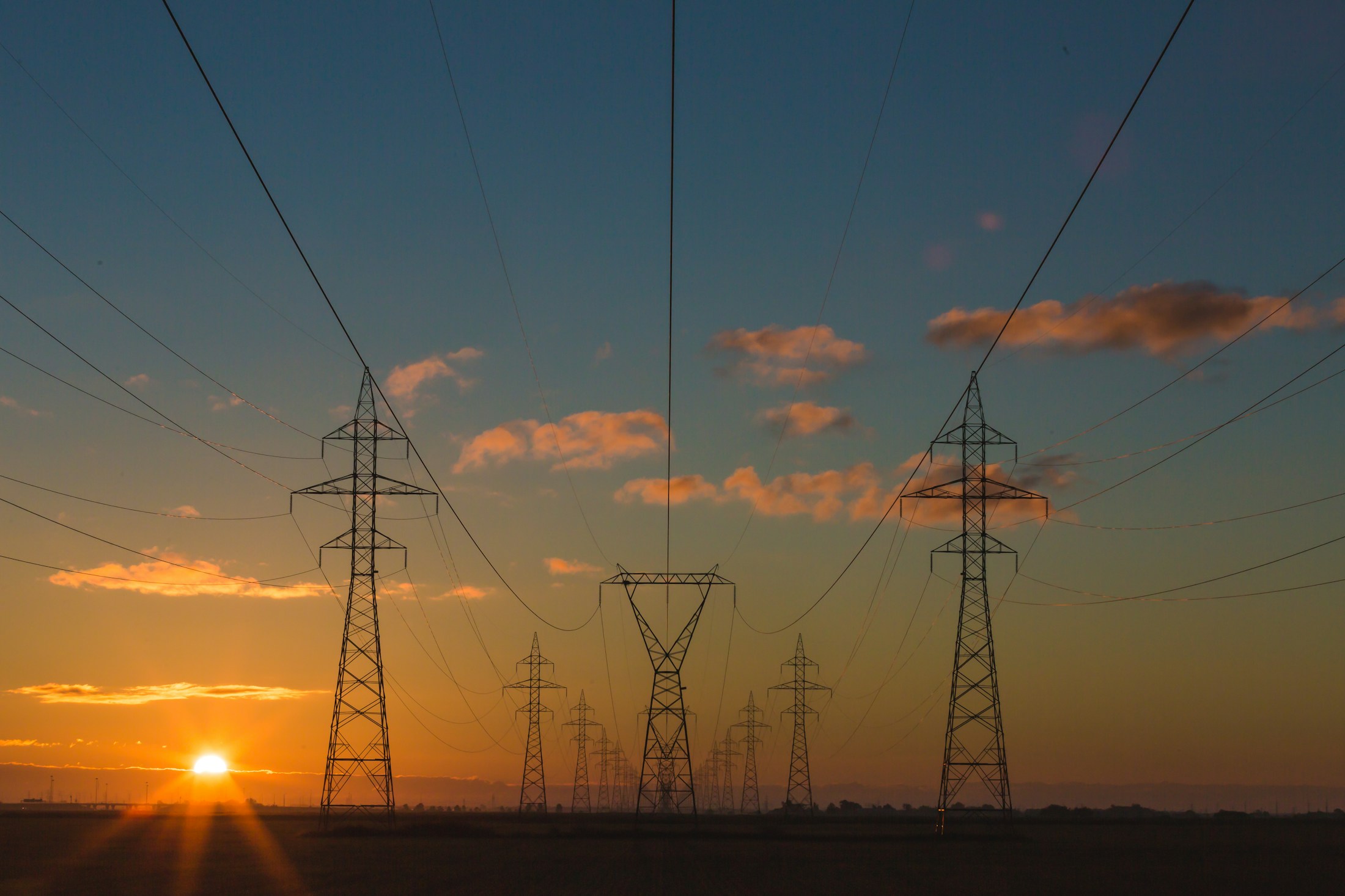 Electricity transmission towers at dusk