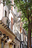 View of the charming street outside Casa Duque, capturing the Madrid neighborhood atmosphere.