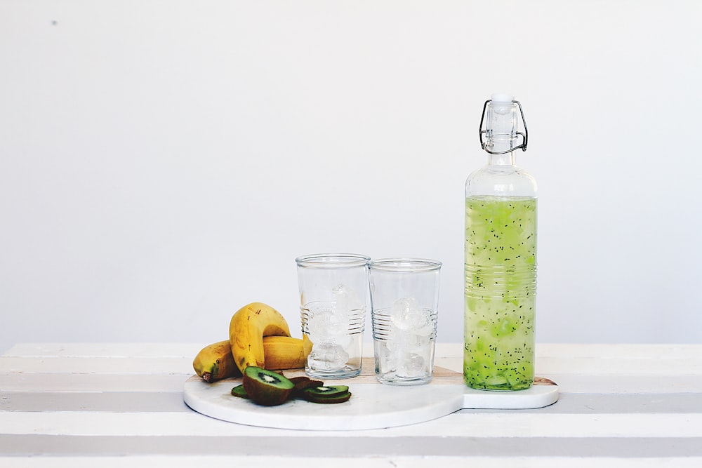 fruit juice and fruits on top of table