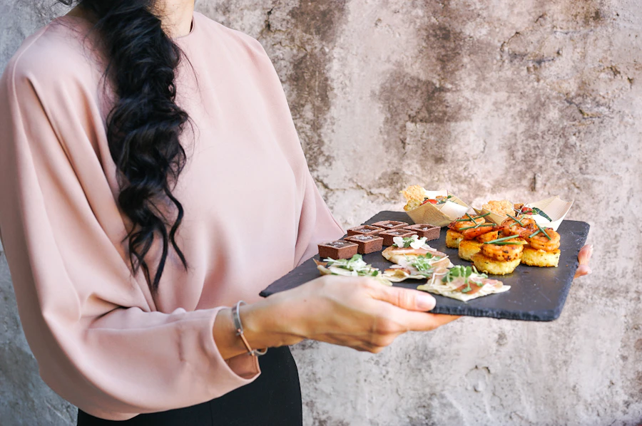 Canapés arranged on a dark serving board.