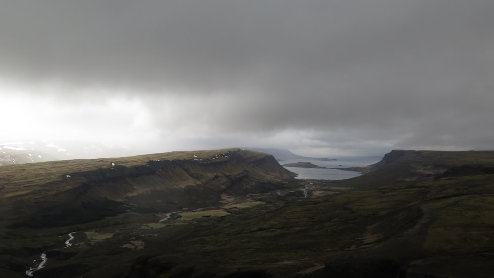 aerial photo of plain under gray cloudy sky at daytime