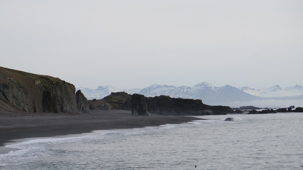 rock formation surrounded by boy of water