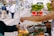 A happy customer holding a bag of fresh produce from Paulo dos Santos.