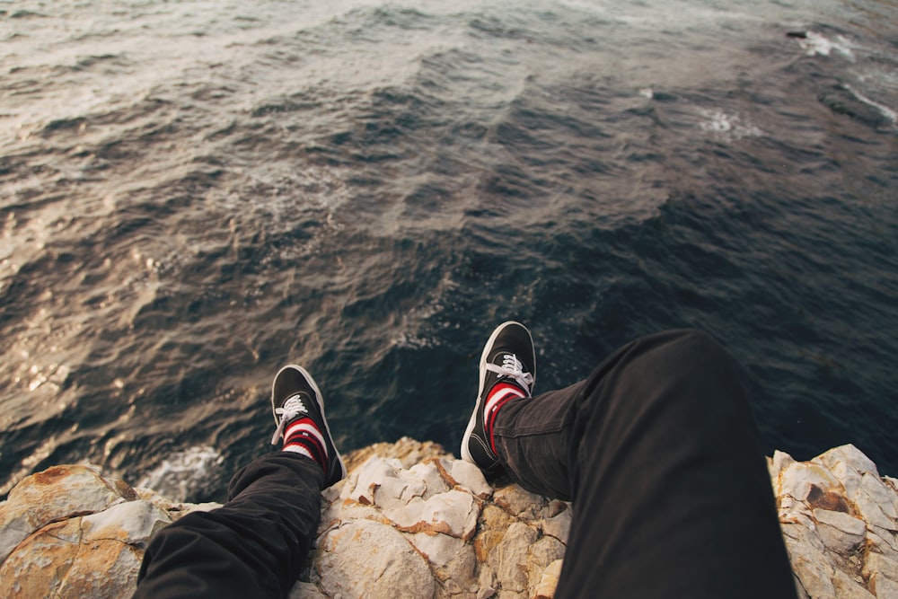 man sitting on cliff