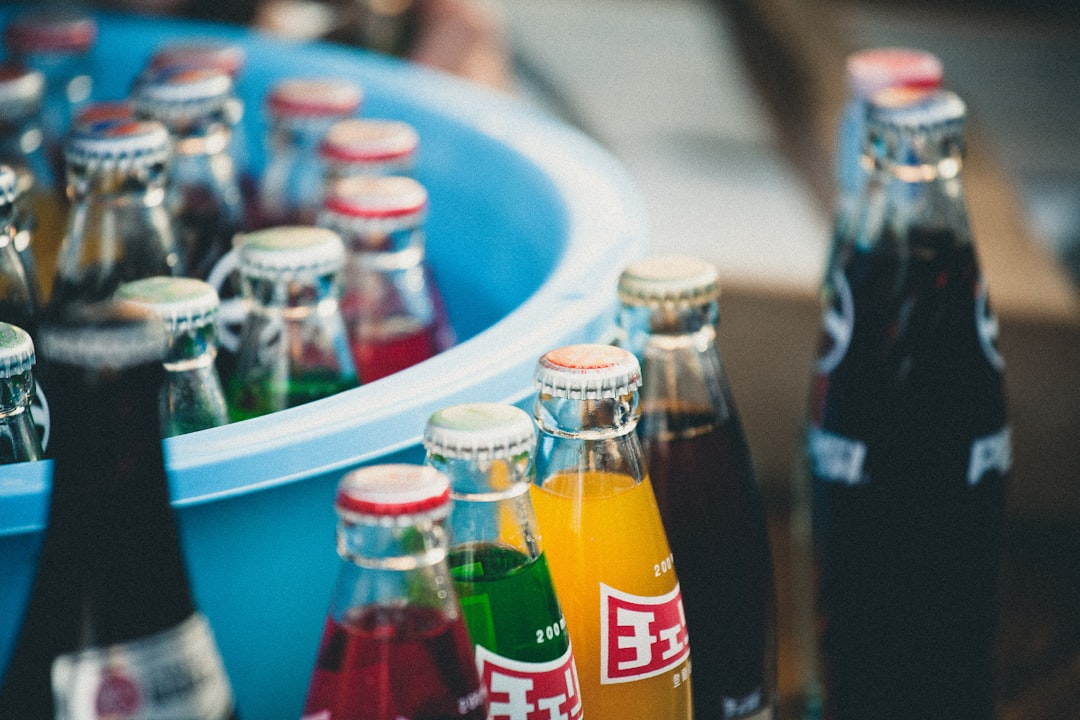 closeup of soda bottles beside basin,