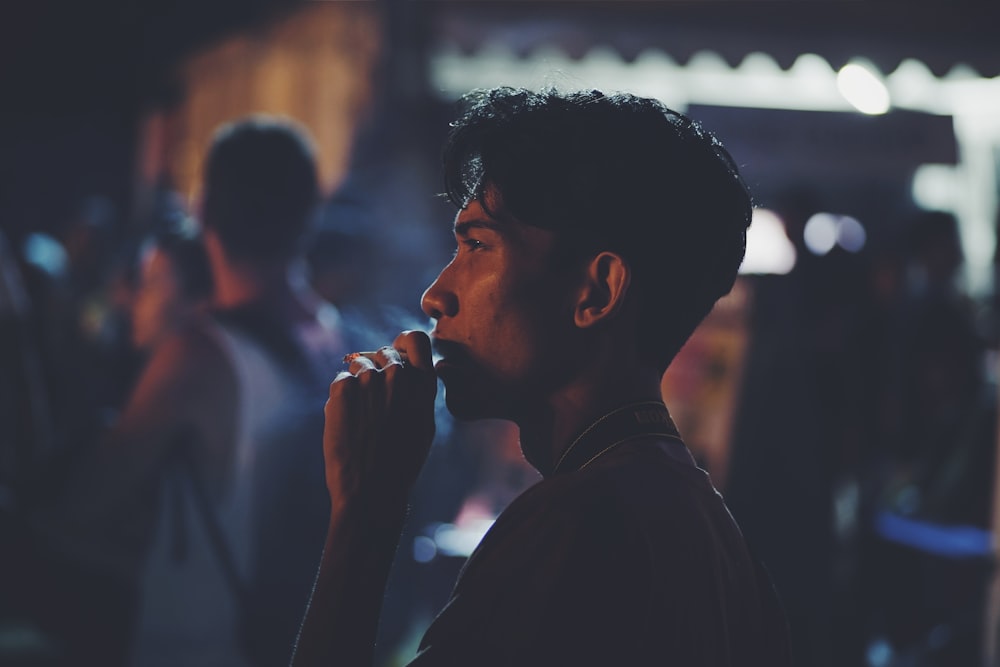 man smoking cigarette at night