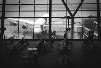 A serene airport scene with passengers waiting at the gate.