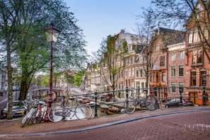 A charming canal view in the Netherlands with traditional houses and bicycles.