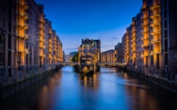 canal between buildings during nighttime
